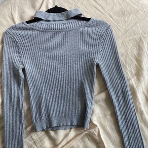 Ribbed crop sweater with detail at neck.
